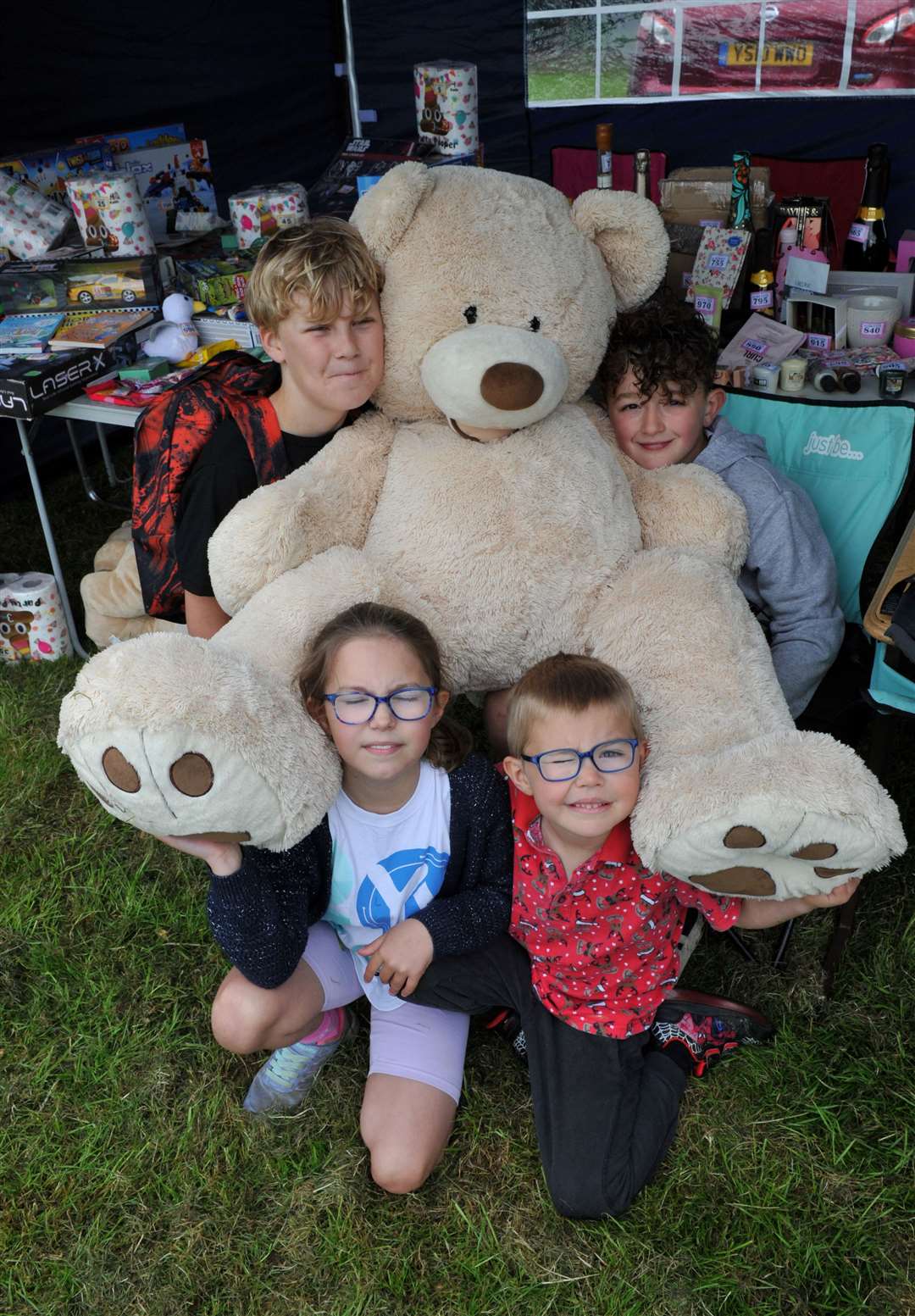 Flynn, 10, Jacob, 10, Lucy, 8 ,and Ben, 6 ,with giant teddy on a stall at Pinchbeck Carnival. PHOTOS: CHRIS LOWNDES