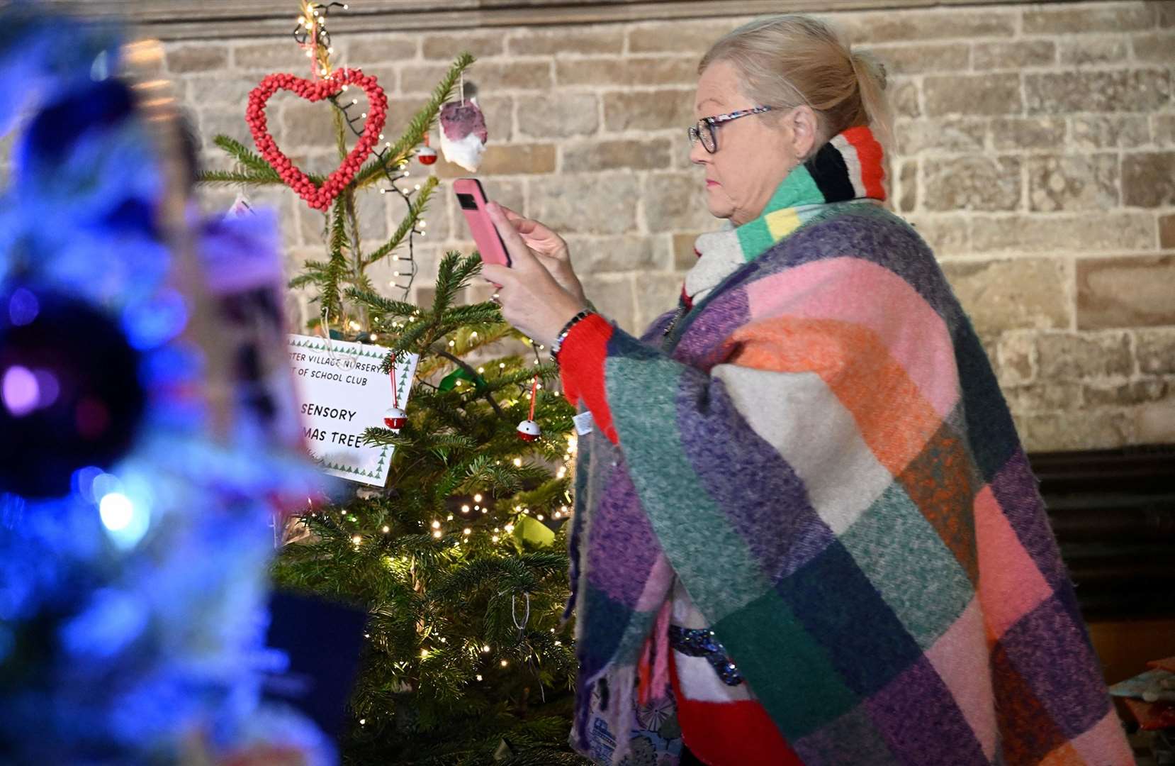 Visitors enjoying the St Wulfram's Christmas Tree Festival and skating rink.