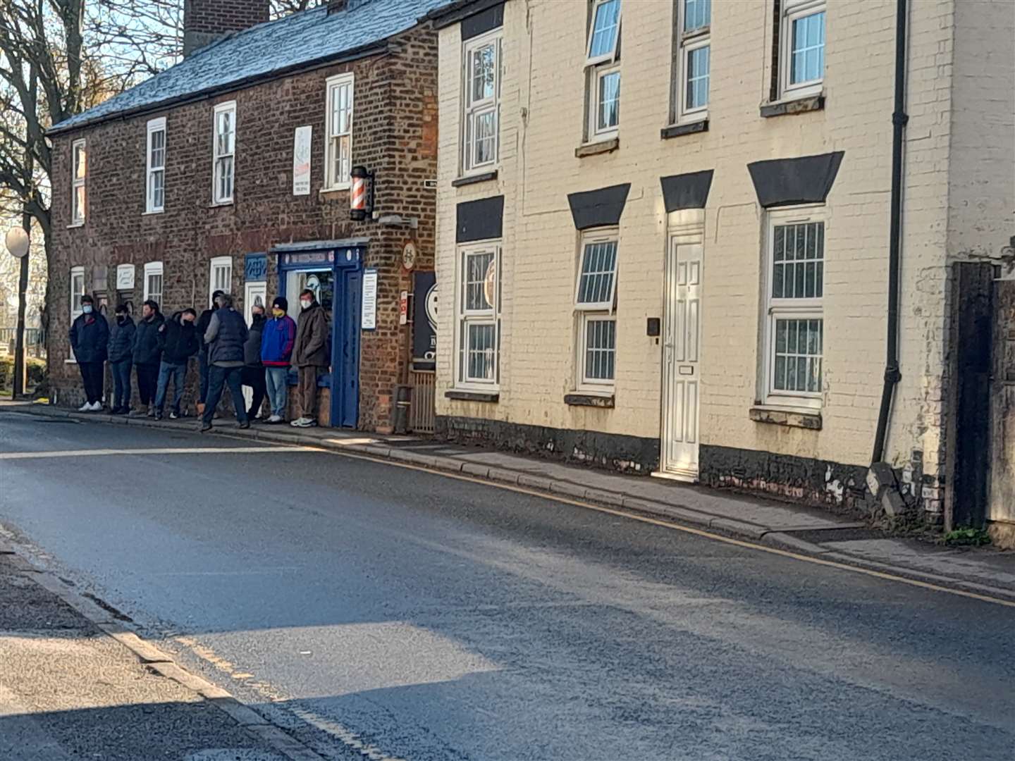 A queue outside FJ Barber's in Spalding on April 12 (46066880)