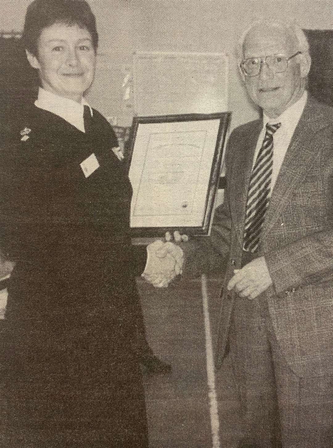 Neighbourhood watch co-ordinator Philip Day receives a Community Service Achievement award from the chief superintendent Fiona Barber 25 years ago