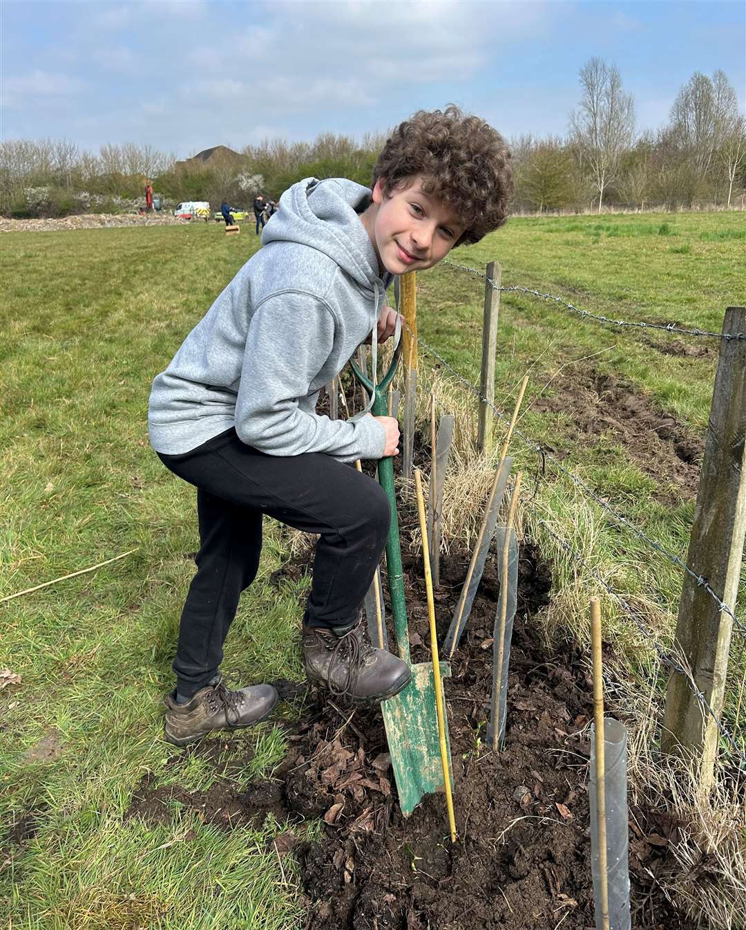 Jasper Blackwell digs a hole for the tree