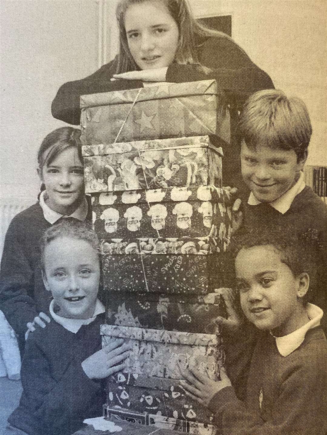 Peakirk-cum-Glinton Primary School pupils Amelia Tilson Smith, Rebecca Henthorn, Carla Hovell, Jason Burke and Alex Twumasi send an early Christmas present to children in troubled areas 25 years ago.