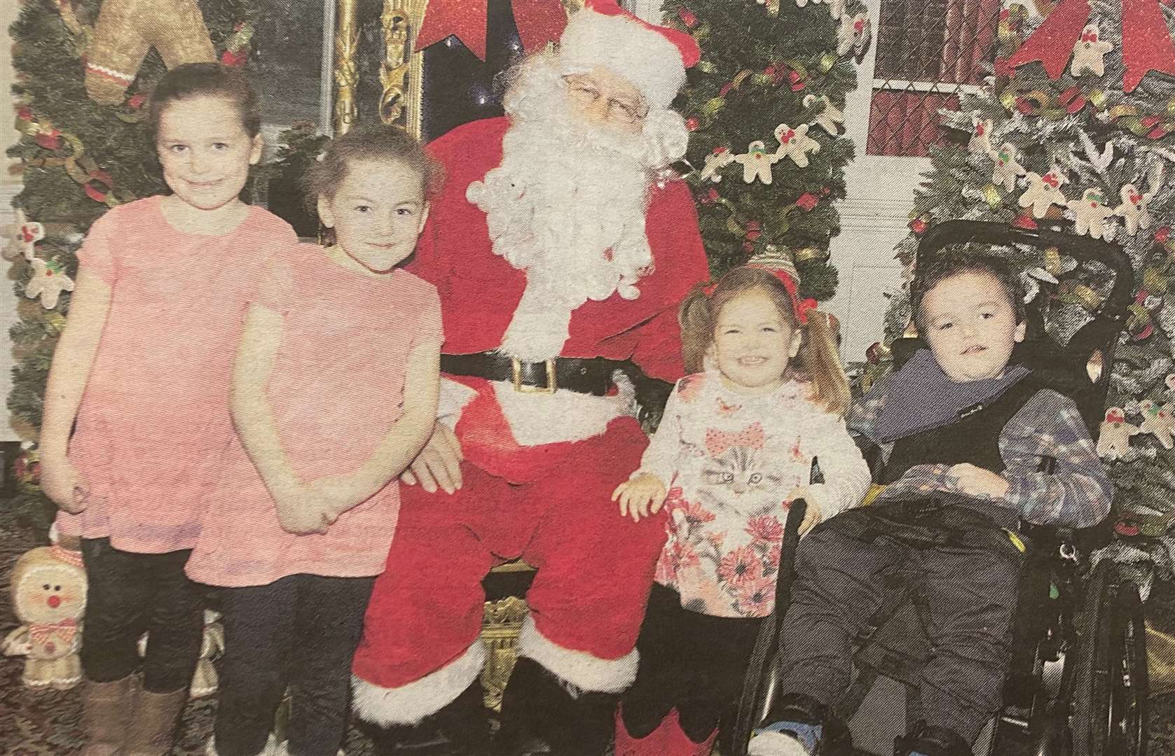 Dylan, five, and his three sisters, six-year-old twins Libby and Layla and three-year-old Daisy with Santa at 10 Downing Street 10 years ago.