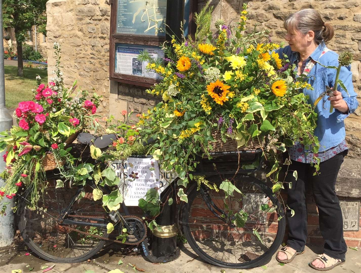 Groups such as Stamford Flower Club welcome new members to join them through social prescribing. Pictured is club member Yvonne Wagstaff putting the finishing touches to a display in the town last year.