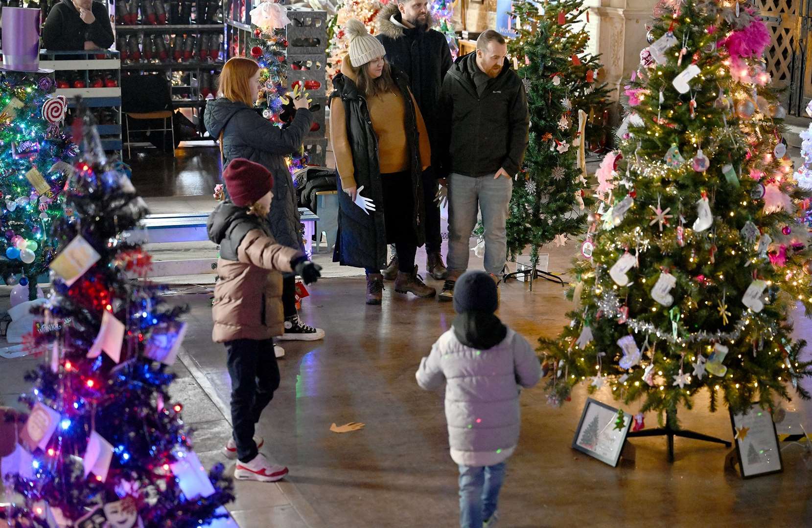 Visitors enjoying the St Wulfram's Christmas Tree Festival and skating rink.