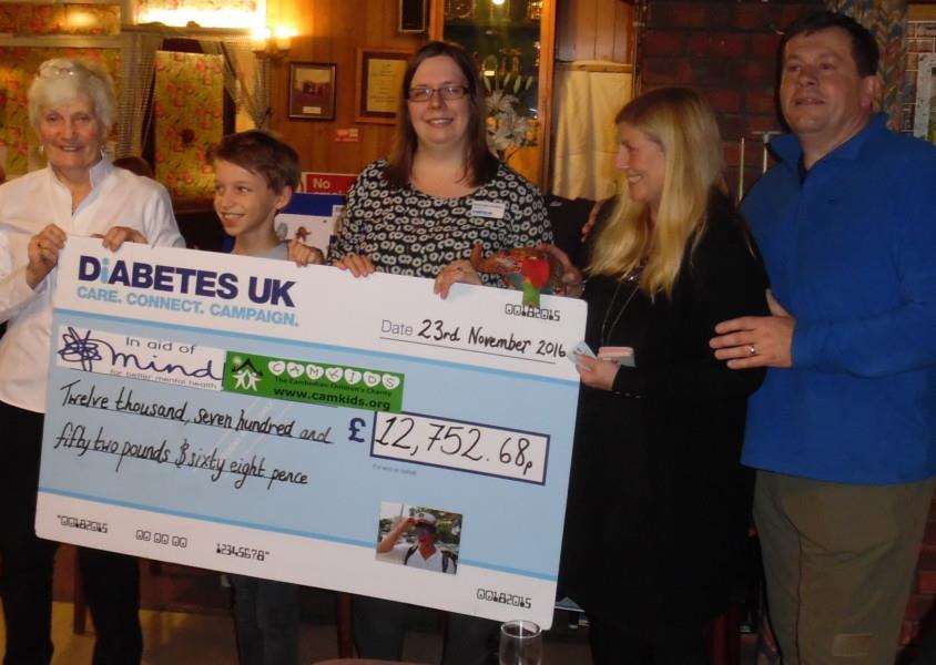 Ges and Mick Riley, right, present a cheque to Rachel Mann-Bradbury, representing Diabetes UK, Ketton Primary School pupil Jonty Williamson representing the school's adopted charity CamKids and the manager of the Stamford branch of Mind Vicky Easton.