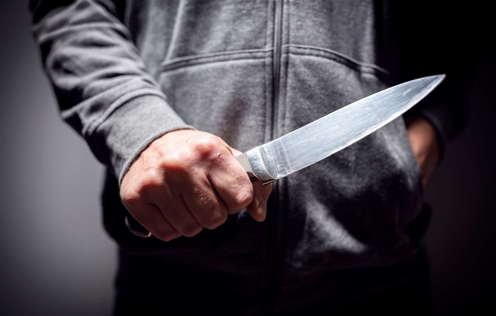 Criminal with knife weapon threatening to stab.