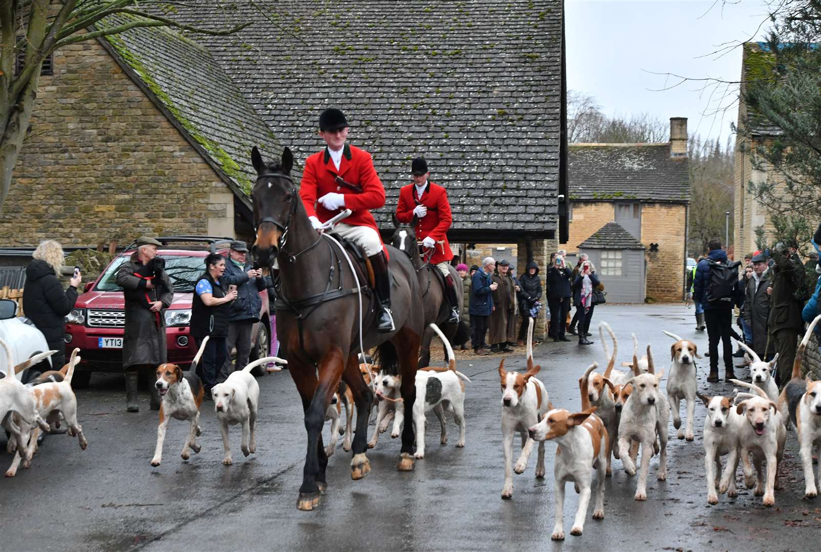 Hounds and riders leaving The Barn behind the Haycock Manor Hotel. Photo: David Lowndes