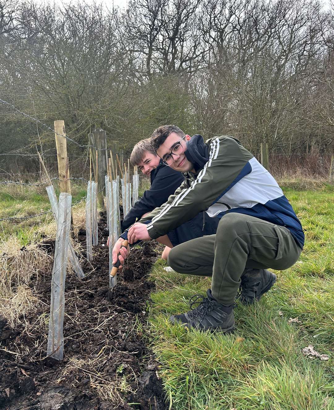 William Farrer and Theo Isaacs planting the trees