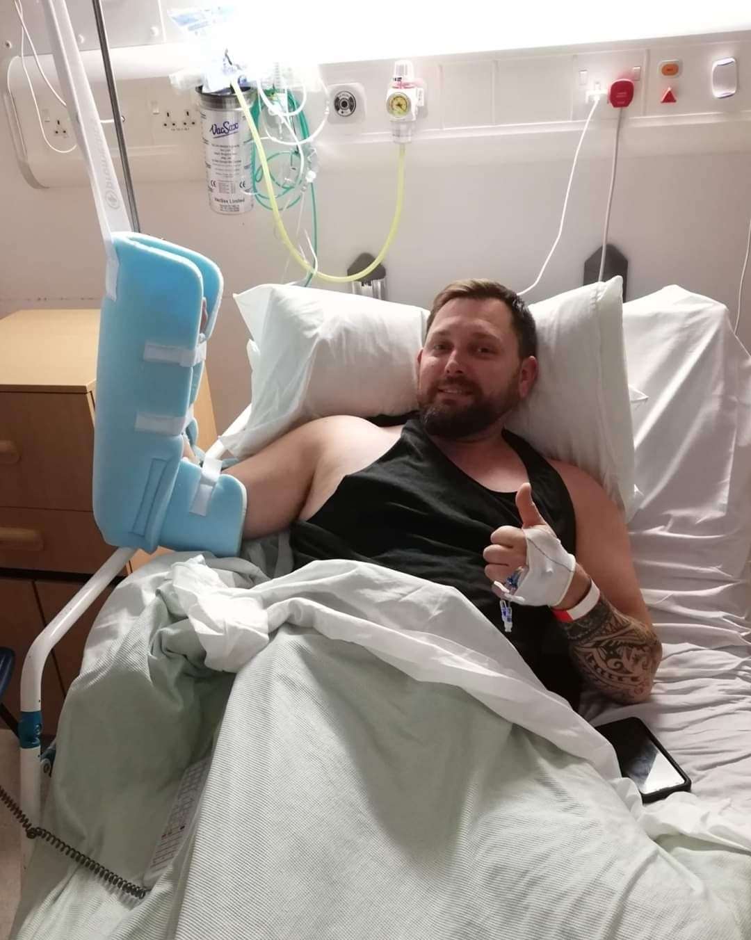 John Whitman in hospital after losing his arm.