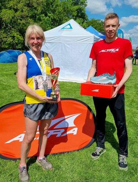 Suzanne Moon receives the trophy for first placed lady at the Grim Reaper 10 mile race.