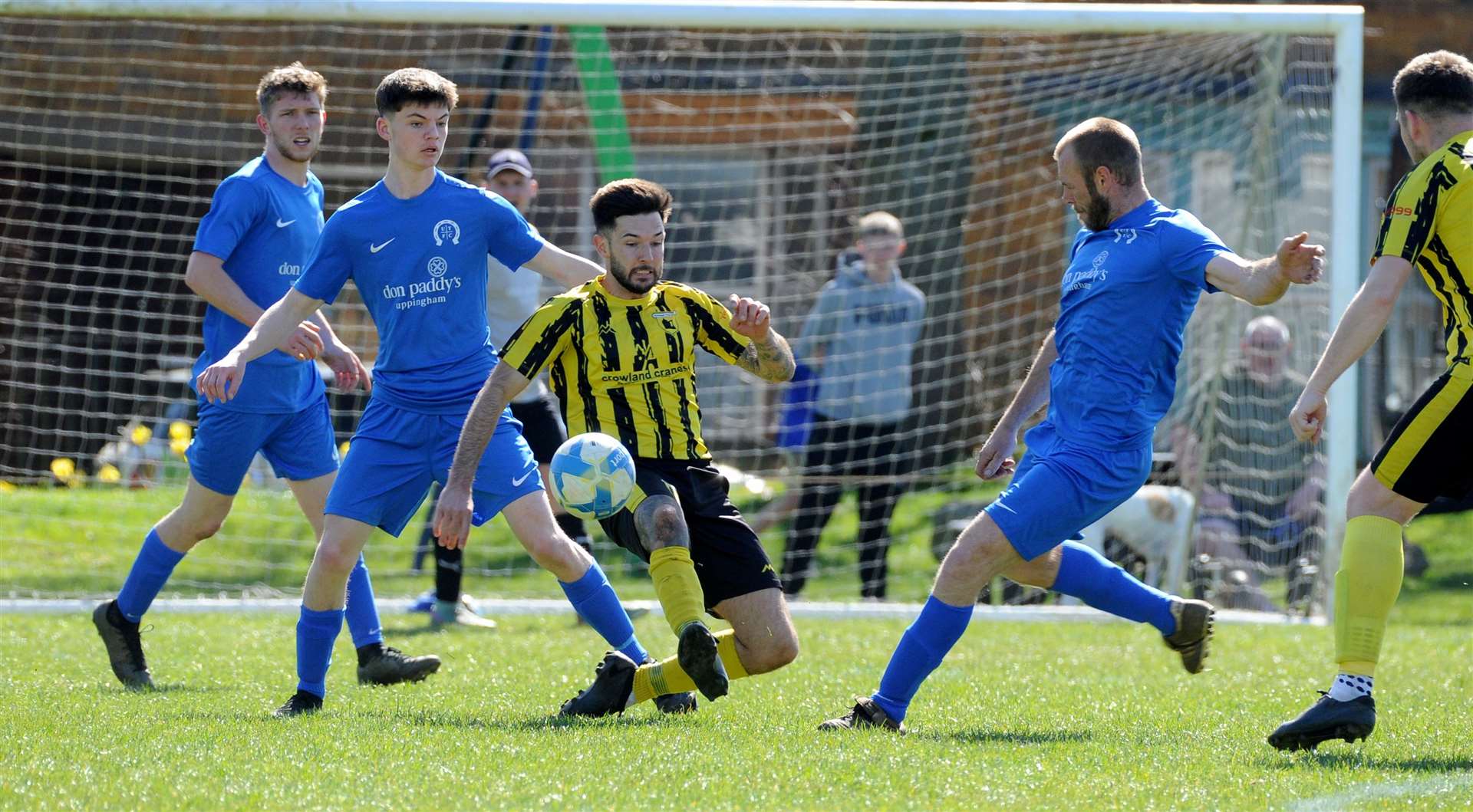 Uppingham Town (blue) try to get ahead of Crowland Town on Saturday. Photos: Chris Lowndes