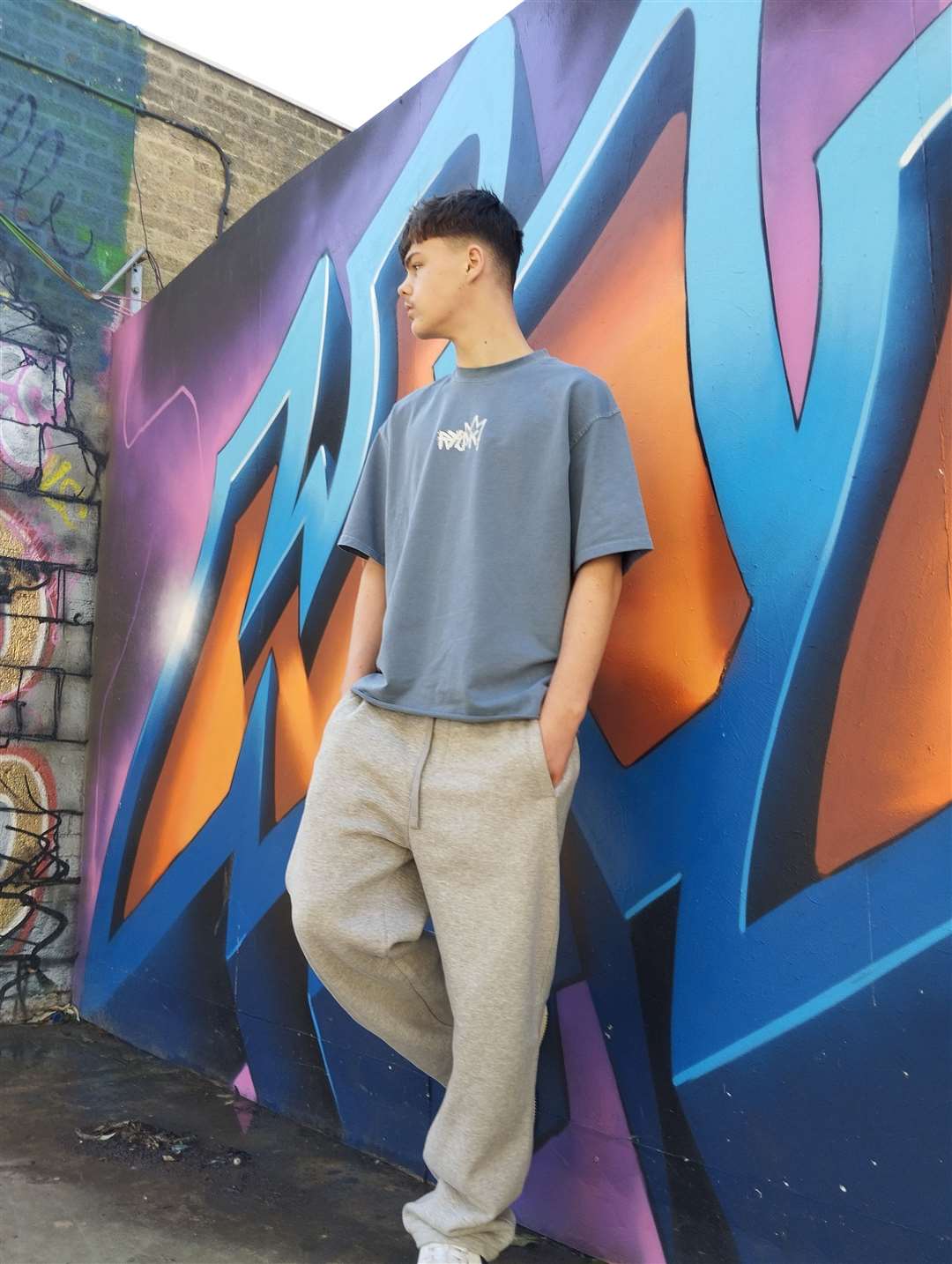 Joshua models a RYSK Streetwear t-shirt, part of the brothers' new sustainable fashion brand. Photo: Supplied