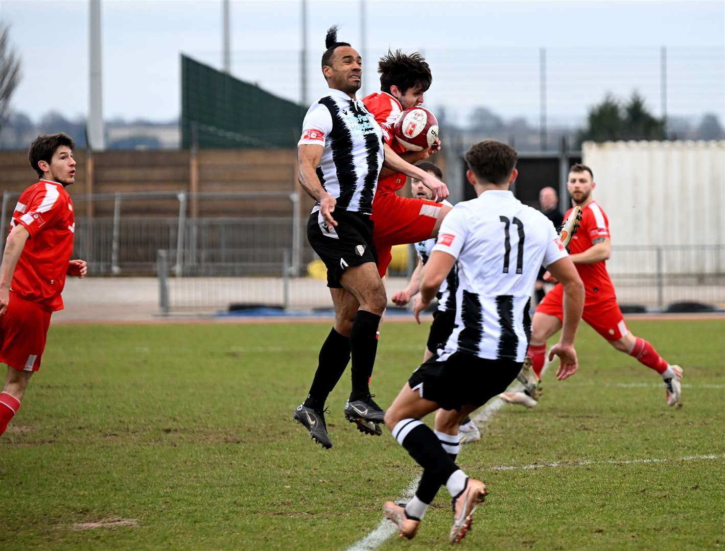 Grantham Town's new signing, striker Chris O'Grady (centre) challenges for an aerial ball with a North Shields opponent. Photo: Toby Roberts
