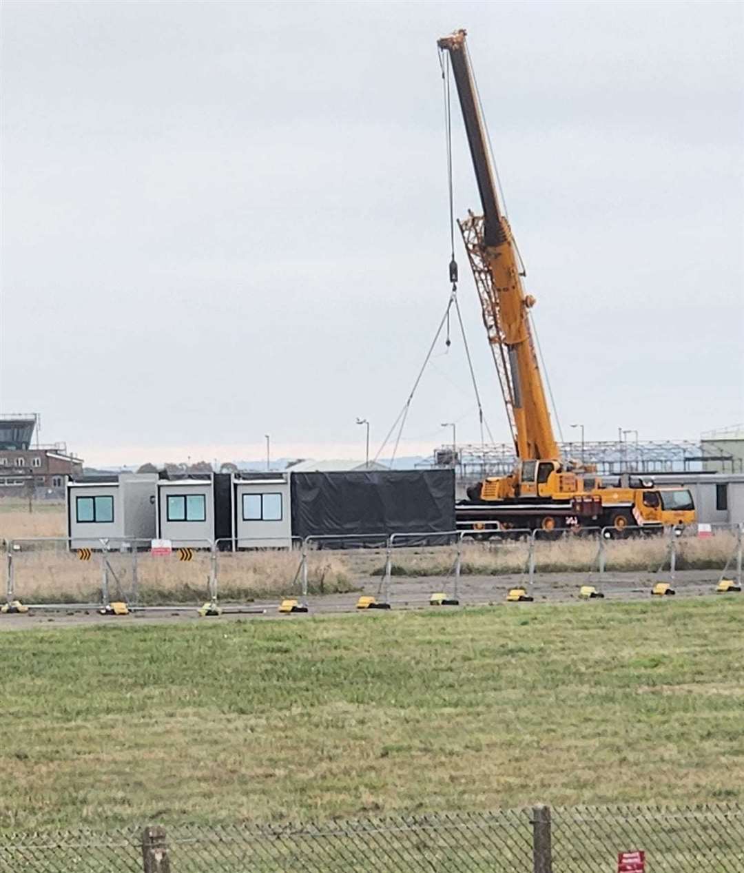 A crane removes portable cabins at RAF Scampton Credit: Sarah Carter