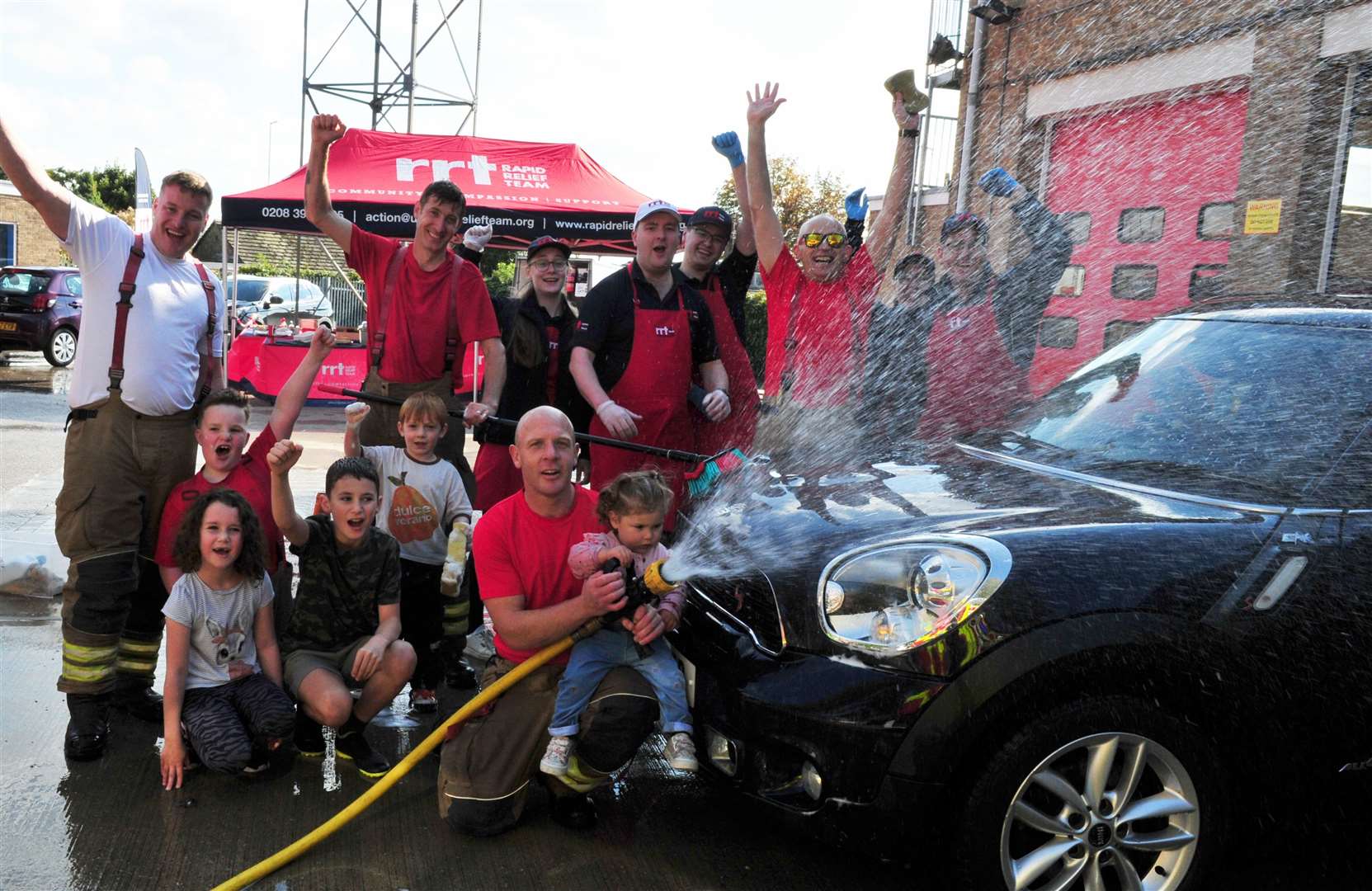Firefighters at the Stamford car wash with some of their younger visitors