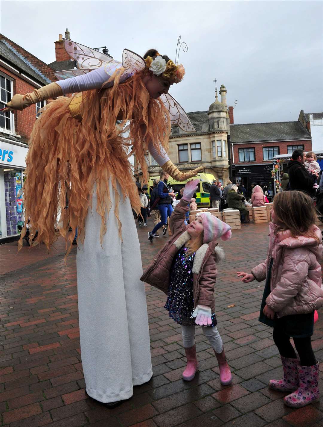 High 5! A stilt walker says hello to a youngster at Spalding Pumpkin Festival