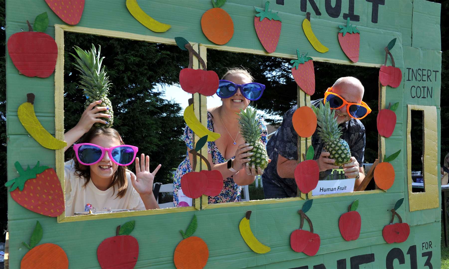 Nine-year-old Phoebe Clarke, mum Claire Clarke, and Nick Ash help out on the 'human fruit machine' game. Photo: Chris Lowndes