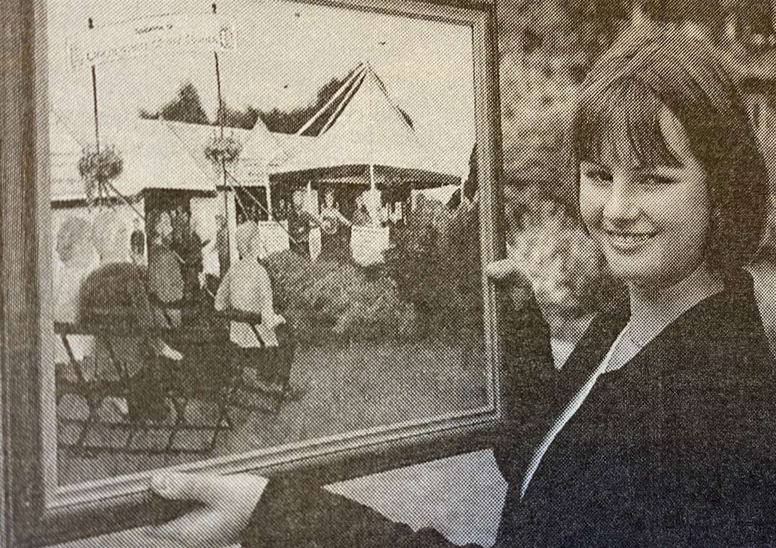 Elena Sandall shows off her painting 25 years ago.
