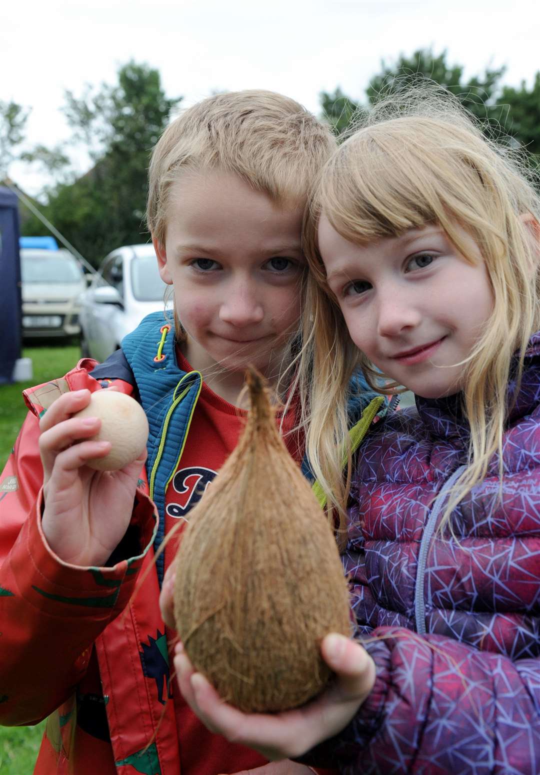Matthew and Izzy Goble, aged 7, try their luck at the coconut stall