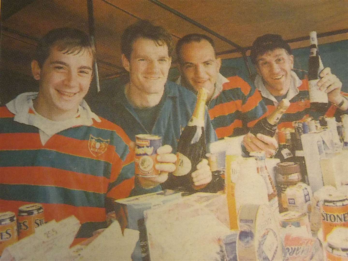 25 years ago: September 18, 1998 – Shelter from the storm: James Genever, Gavin Moss, Phil Danes and Ray Bates take cover on the tomola stall at Stamford College Old Boys fund-raising fete.