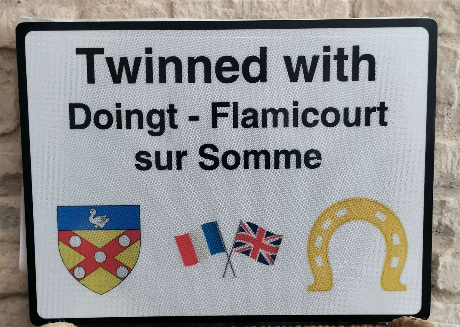 Tinwell's new twinning road sign incorporates the Rutland horseshoe symbol and the shield of Doingt-Flamicourt