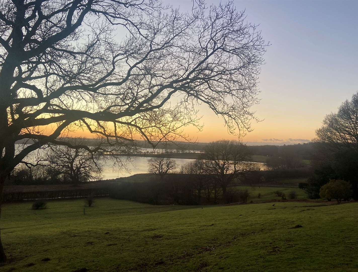 The sun setting over the reservoir in the grounds of Rutland Hall Hotel