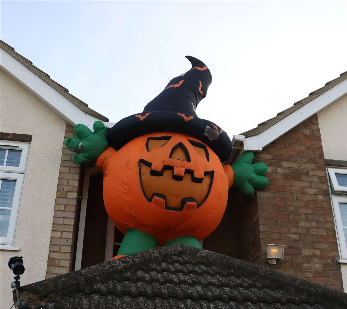 The giant pumpkin sits on top of the porch