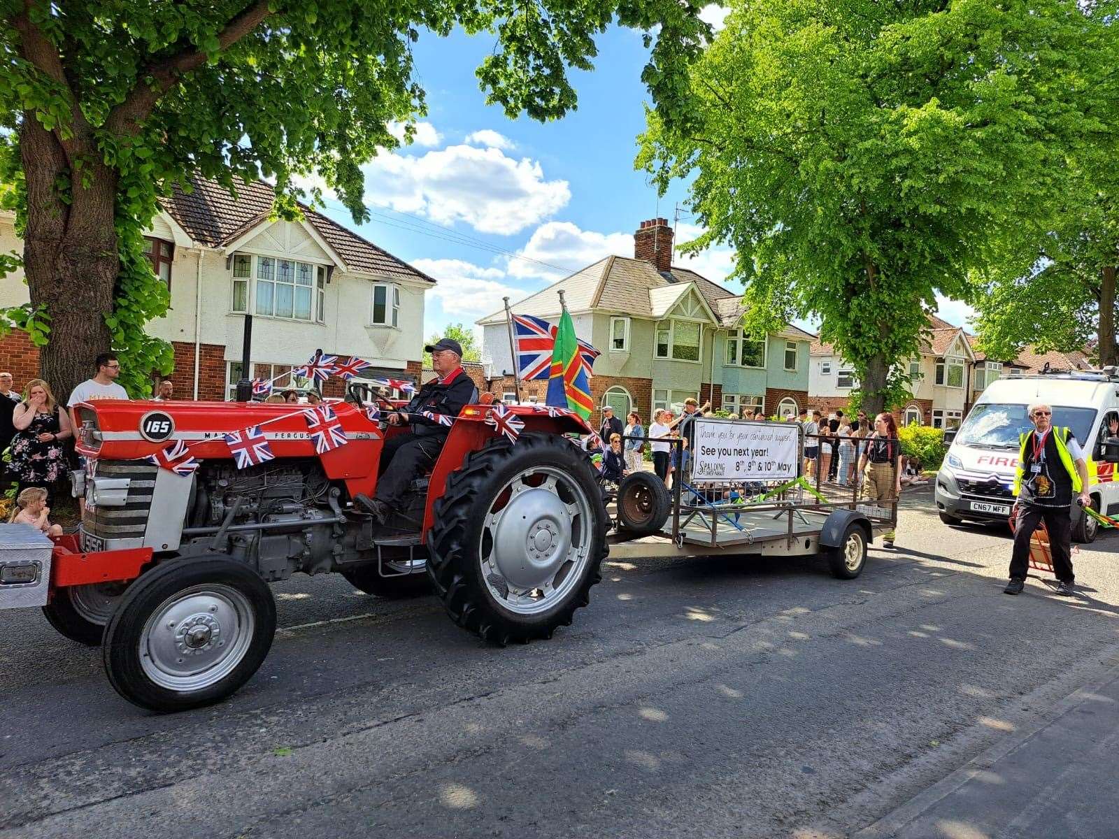 It will be back! The final tractor lets revelers know the dates of next year's parade