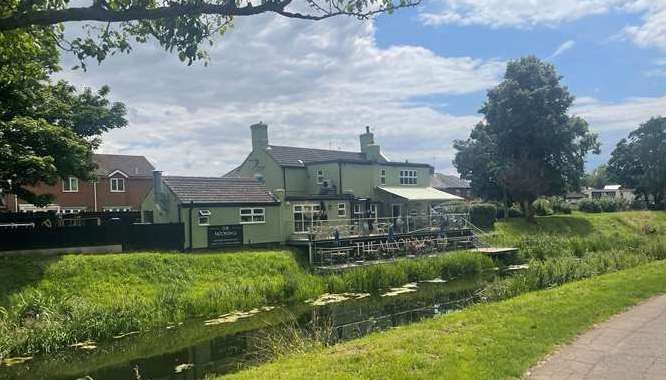The outside seating area overlooks the Welland, and a family of swans