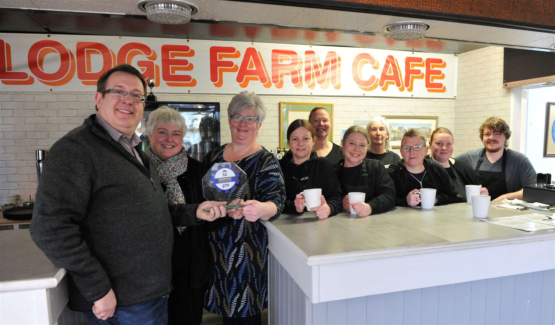 Lodge Farm Cafe owners Susan Dunn and Rebecca Chandler and the team receive the trophy from Pip Dunn