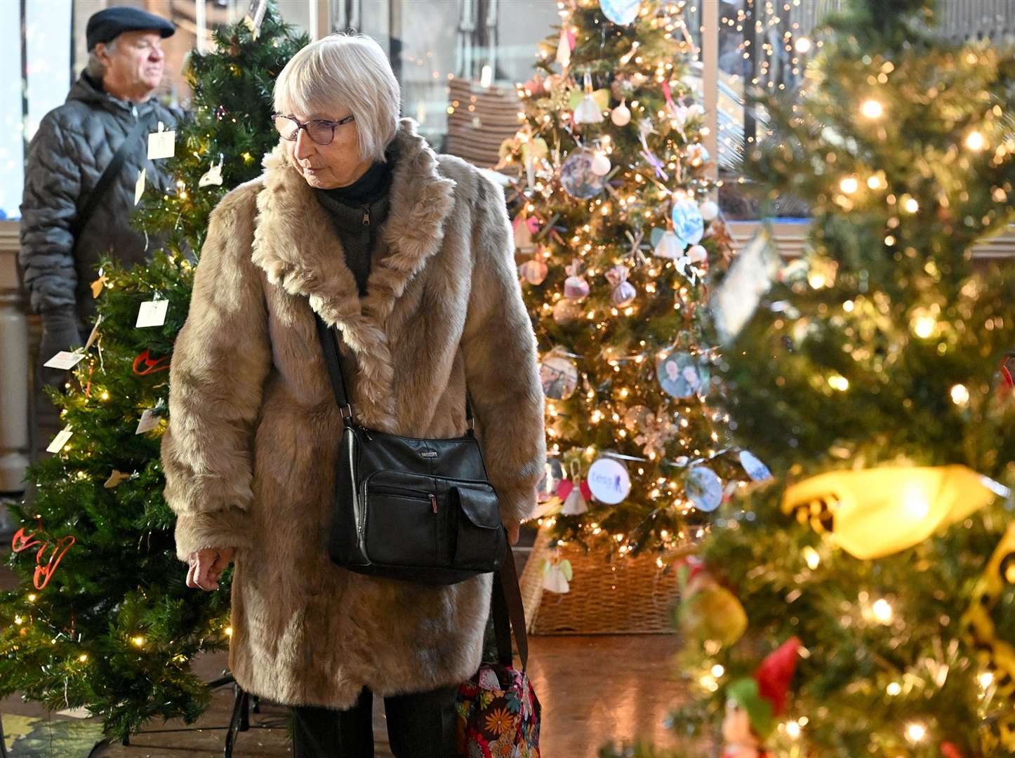 Visitors enjoying the St Wulfram's Christmas Tree Festival and skating rink.