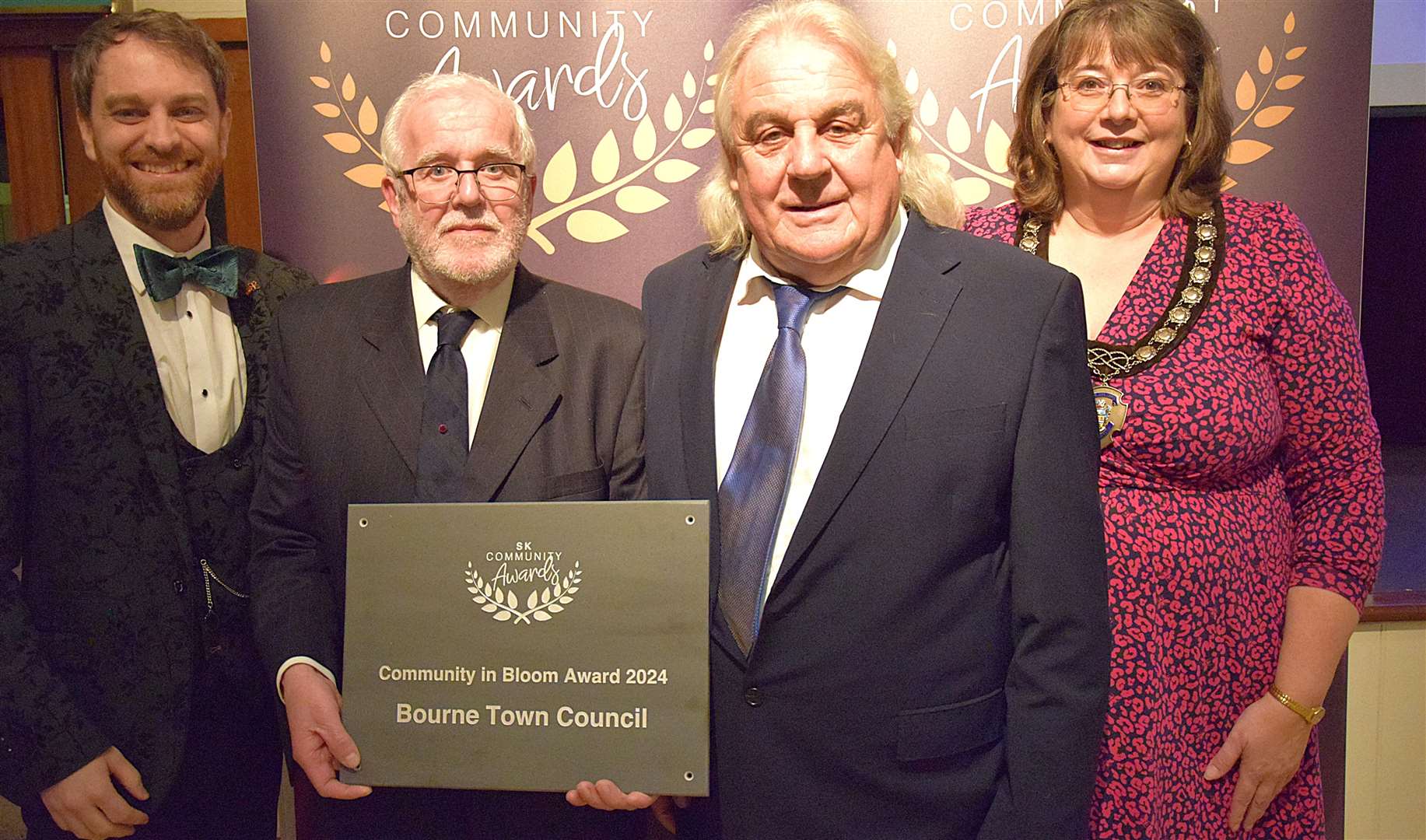 Councillors Rhys Baker and Helen Crawford with Phil Whyles (left) and Bill Pauley, who collected the Community in Bloom Award on behalf of Bourne Town Council.