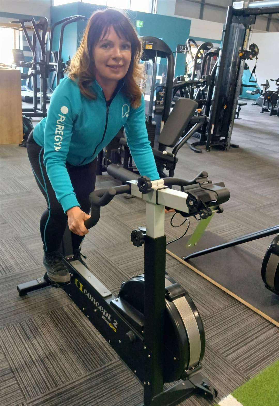 Gym manager Isla Oliver on an exercise bike