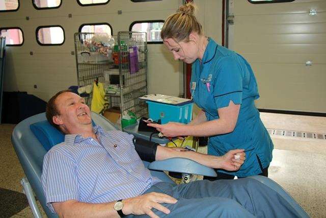Lincolnshire County Council's Executive Councillor for Fire and Rescue Cllr Nick Worth gives blood at the launch of the new pilot aided by Kari Cotton-Betteridge. (2788258)