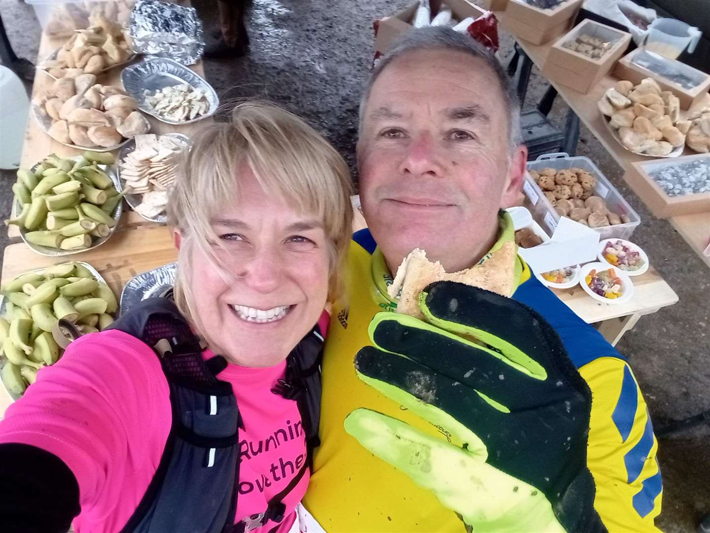 A couple of runners enjoy a food station along the route