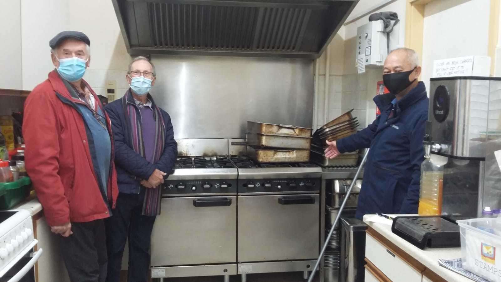 President Yim Kong (right) with Roger Adams and Geoff Collet of Stamford Rotary St Martins inspecting the old kitchen