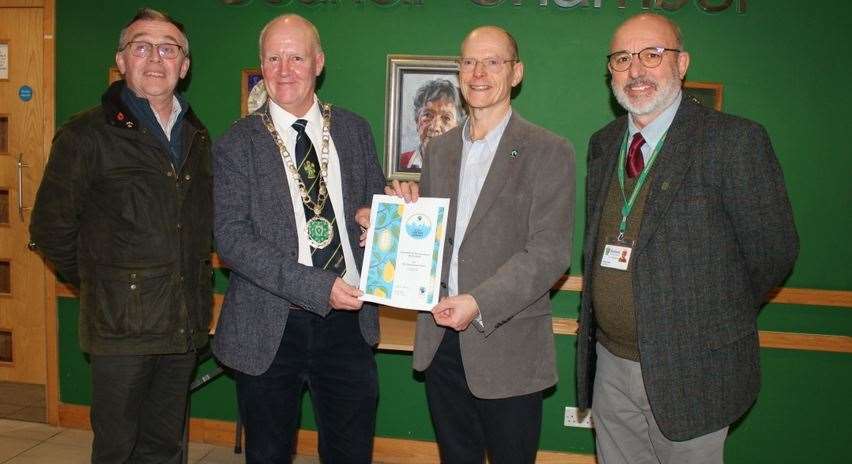 The Fairtarde County certificate is presented to, from left, High Sheriff of Rutland, Richard Cole, RCC chairman Coun Andrew Brown, Rutland Fairtrade Forum chair David Lewis, and Coun Kevin Corby, the RCC representative on the Rutland Fairtrade Forum
