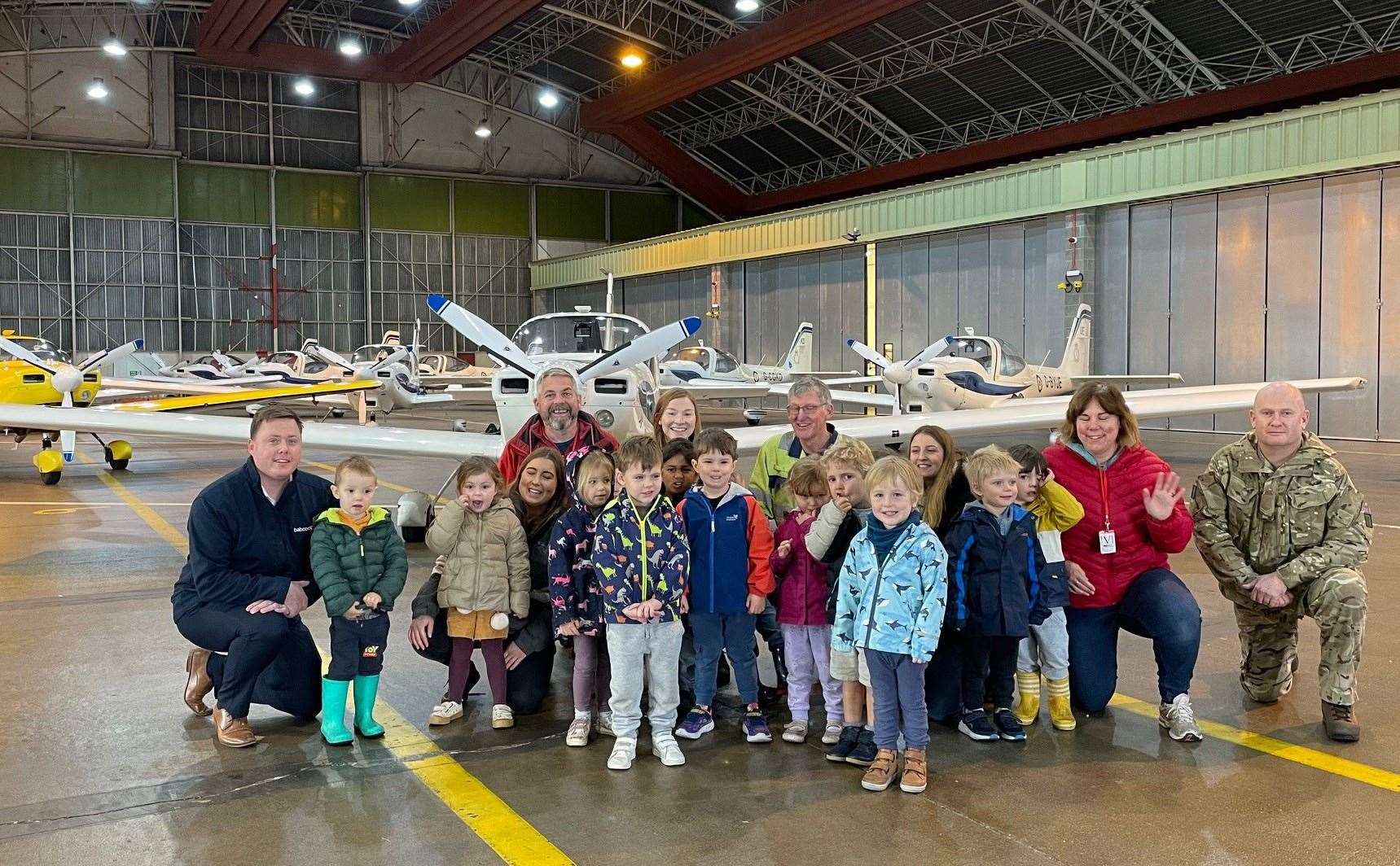 Children’s Garden Day Nursery youngsters with teachers and RAF personnel