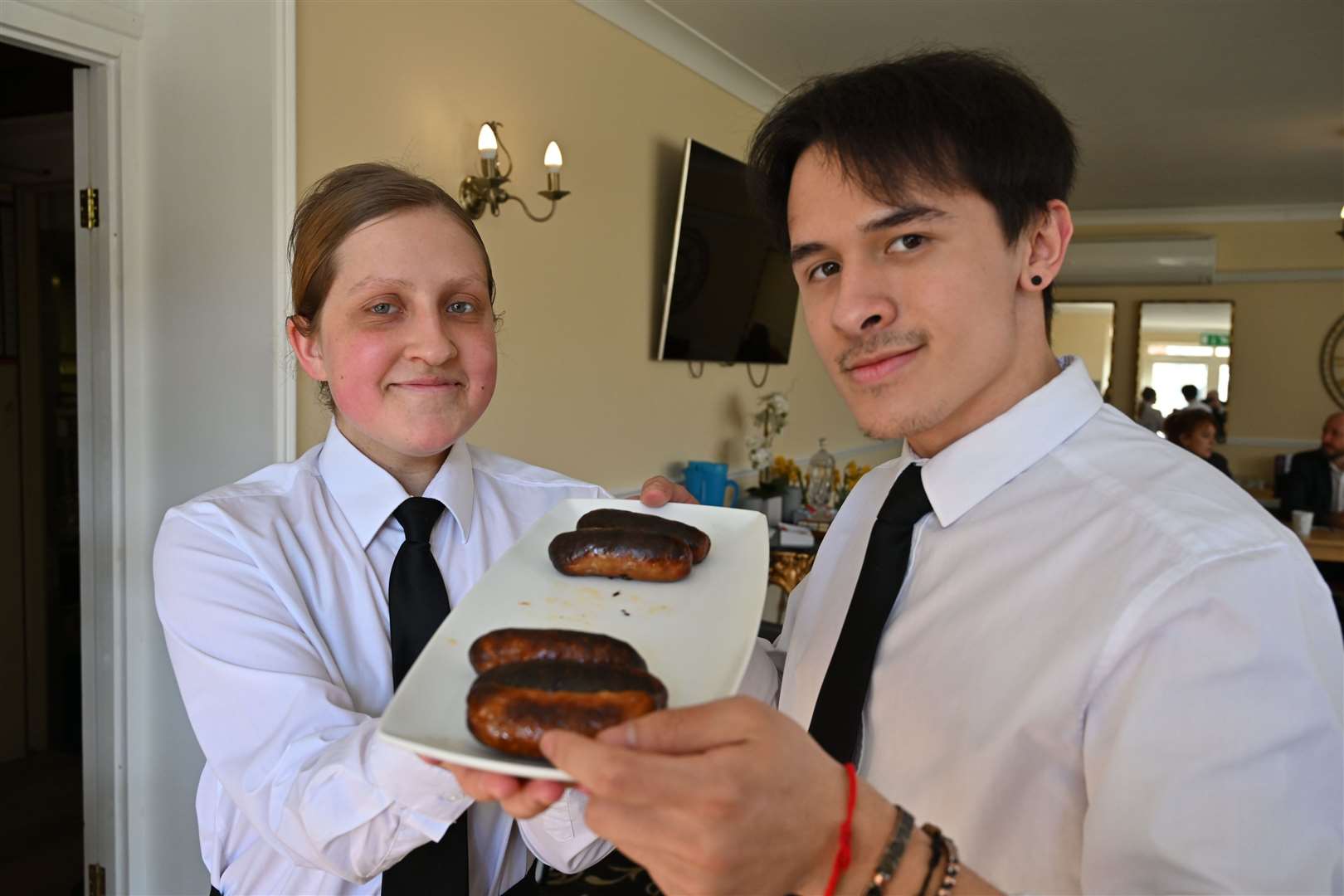 Boston College catering students Alexandra Pelley and Matt Smith served up the sausages