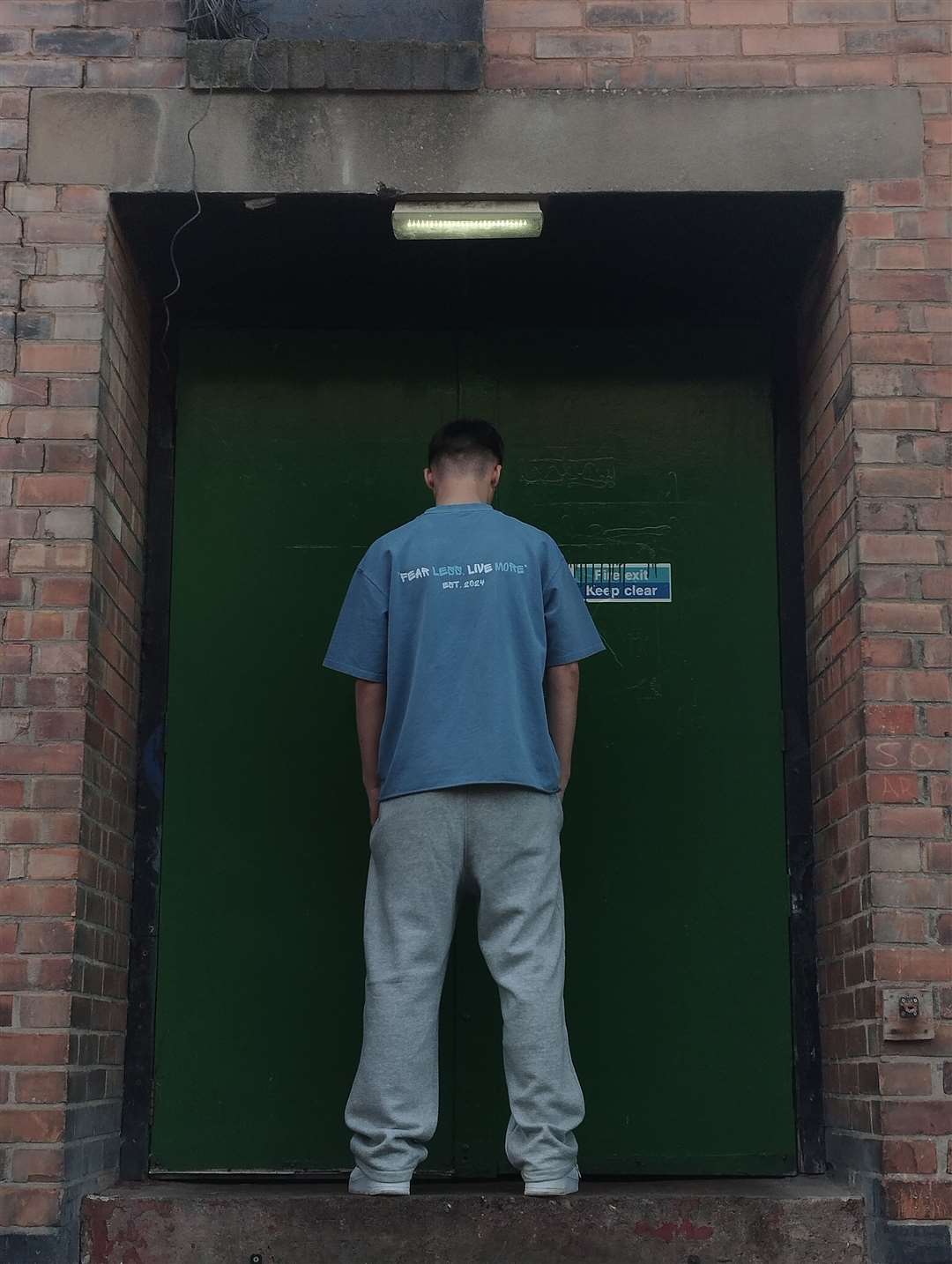 Joshua wears one of the brand’s t-shirts, designed to promote confidence and stepping outside your comfort zone. Photo: Supplied