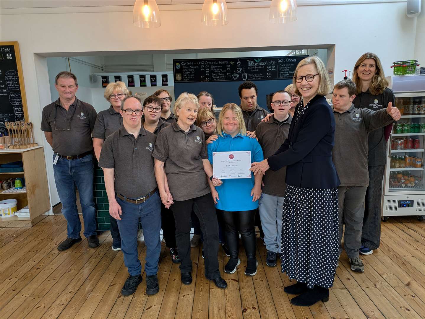 Members of the Birch Tree Cafe team receive their Rose of Northamptonshire Award from deputy Lord Lieutenant Anne Burnett.