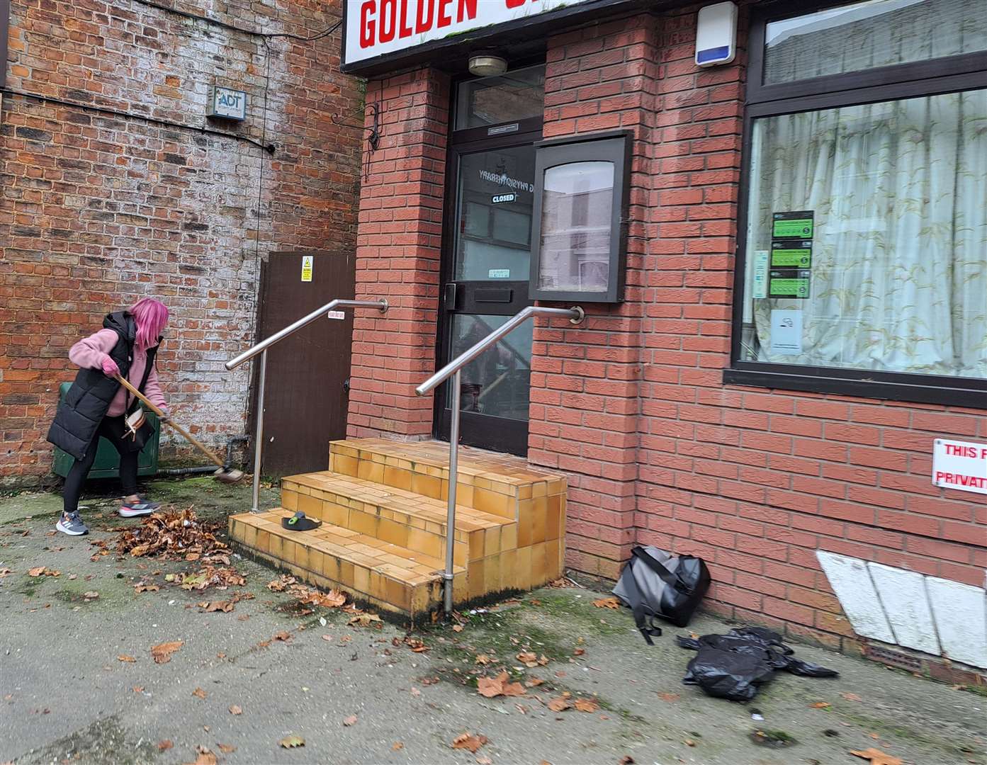 Mental health advocate, Vanessa Browning clearing old leaves and rubbish