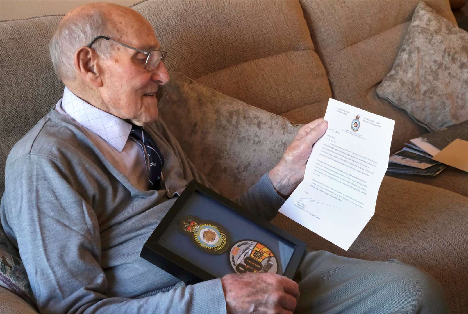 Terry with his letter and gift from the Canadian 433 (Porcupine) Squadron. Photo: Supplied