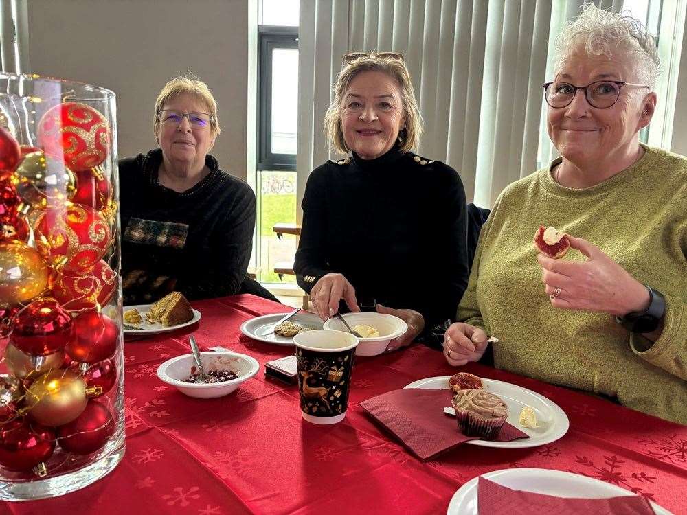 Some happy grandparents with their tea and cake.