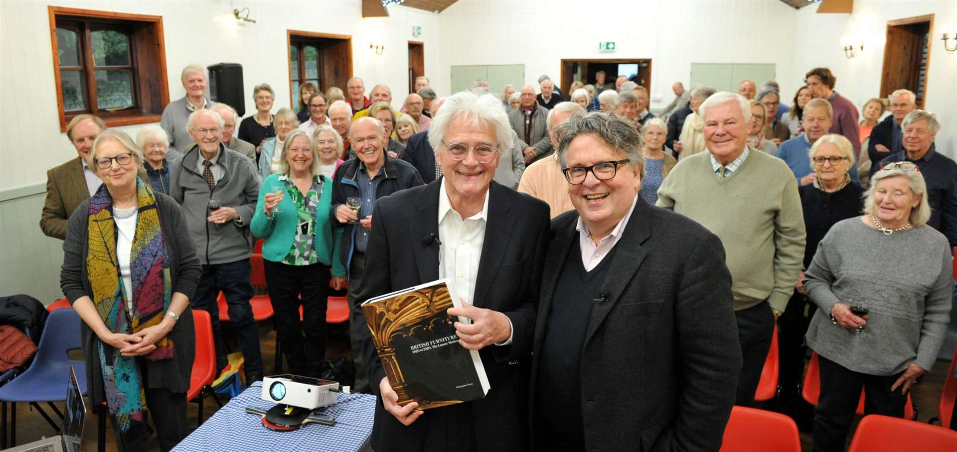 Antiques Roadshow experts Christopher Payne and Lars Tharp with some of the audience who helped 'raise the roof' for St Mary's. Photo: Chris Lowndes
