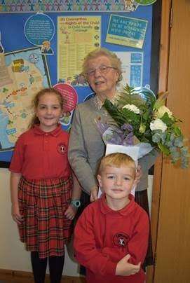 Nora Bryan is presented by gifts and a card by pupils of Cliffedale Primary School. (5229364)