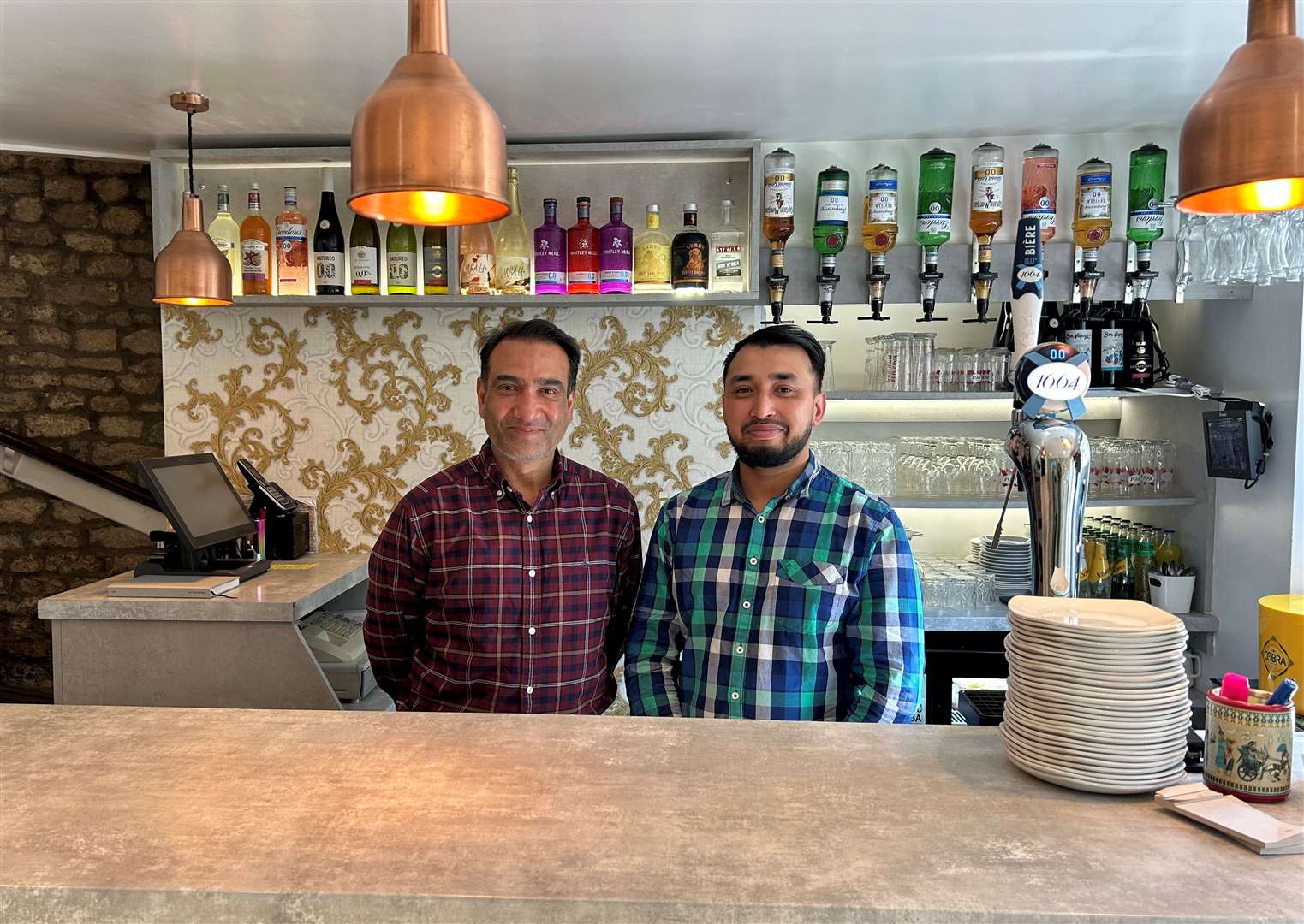 Owner of Bombay Cottage Habib Rahman with front of house and family member Harun