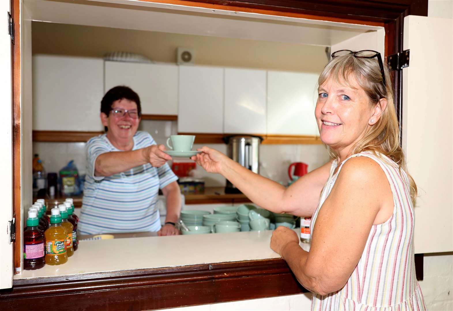 Anne Willson, West Pinchbeck WI treasurer, gets a nice cuppa from West Pinchbeck WI Secretary Wendy Houghton