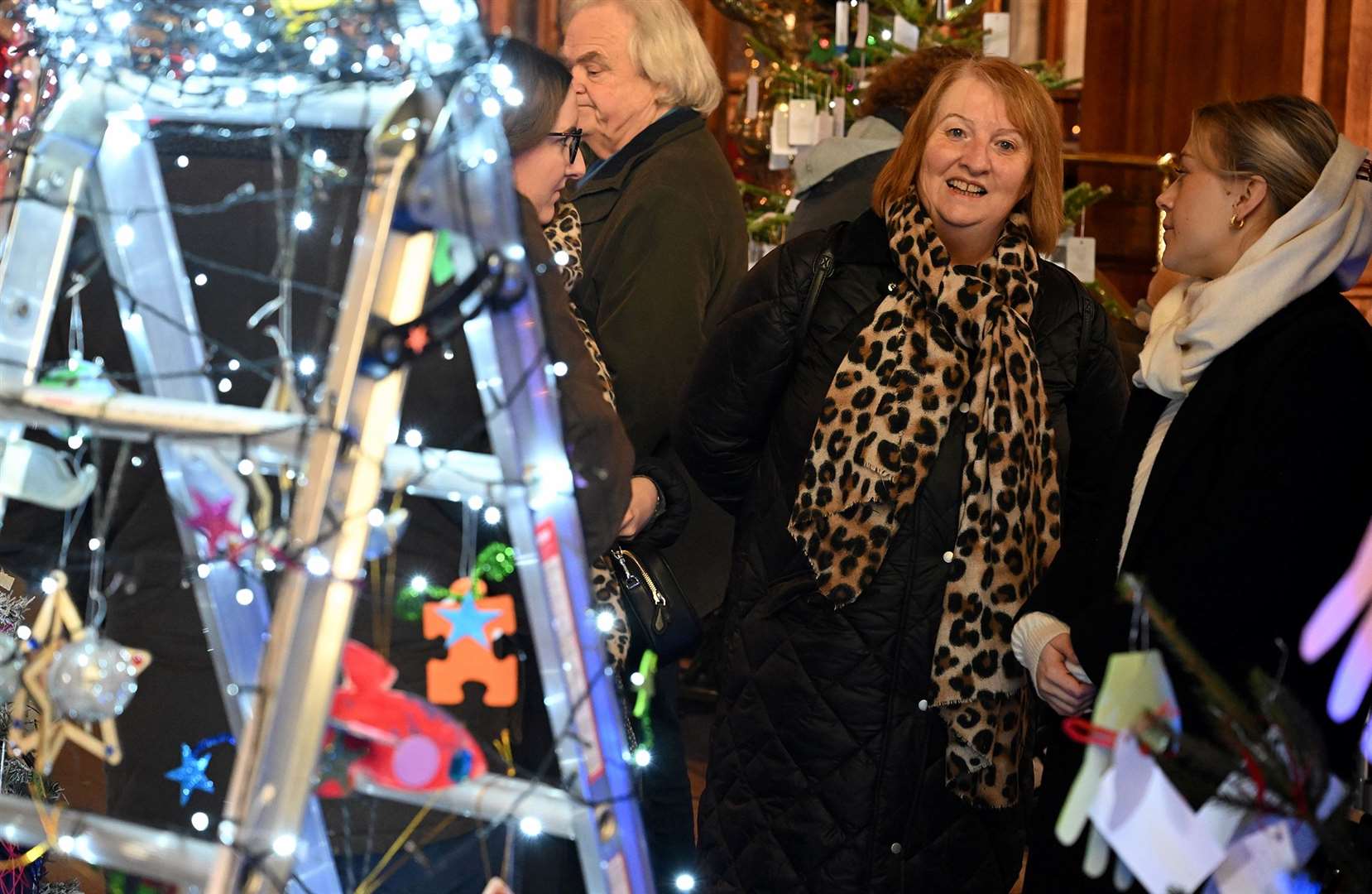 Visitors enjoying the St Wulfram's Christmas Tree Festival and skating rink.